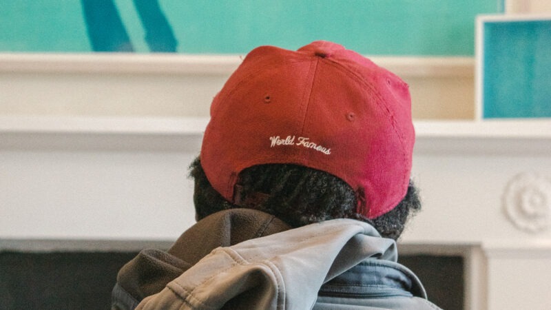 Man in baseball cap in James' Place waiting room London