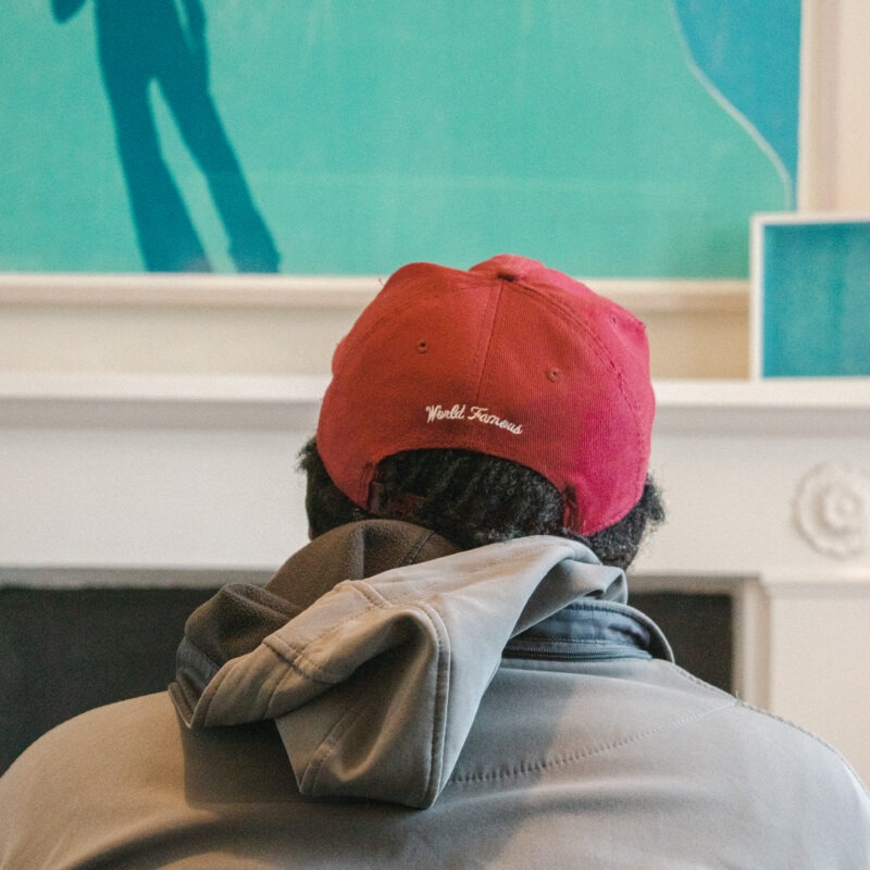 Man in baseball cap in James' Place waiting room London