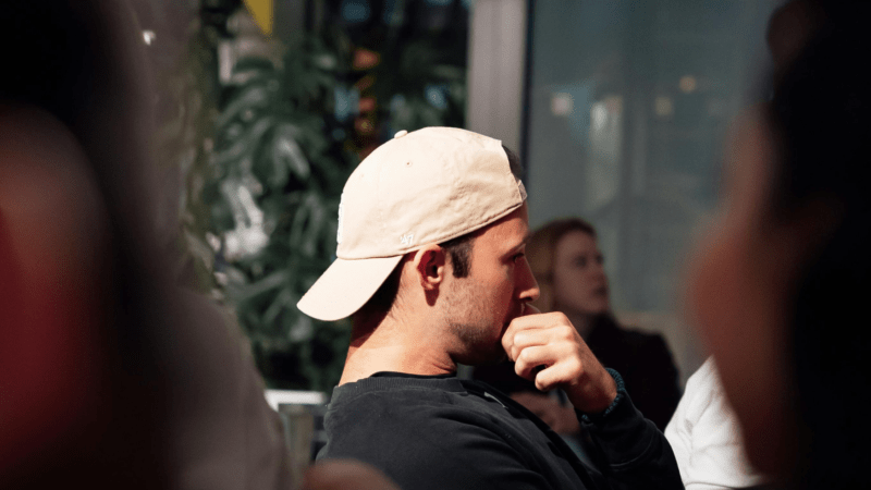 Man in side profile wearing baseball hat