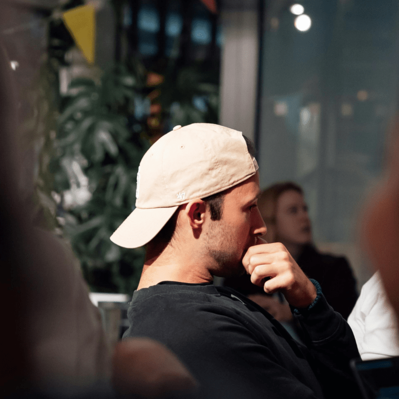 Man in side profile wearing baseball hat