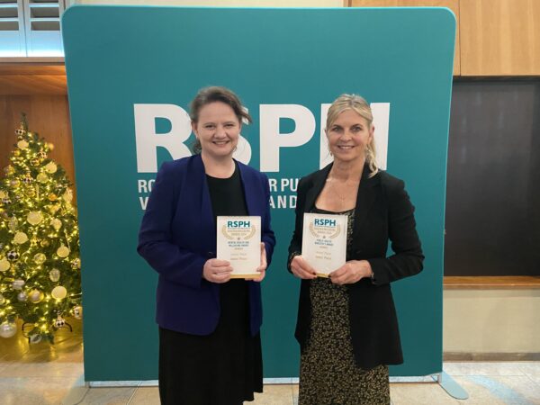 Two women holding award