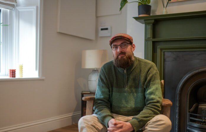 Man in flat cap sat in therapy room at James' Place