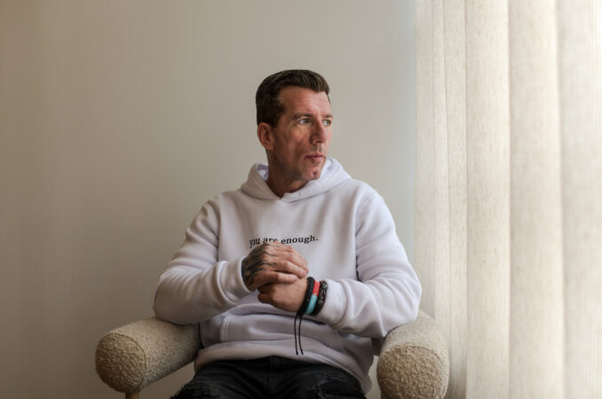 Man sat on a chair and looking out of window