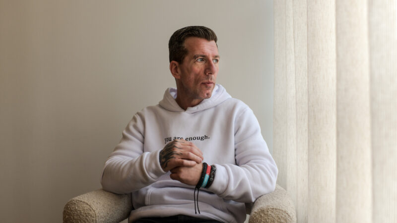 Man sat on a chair and looking out of window