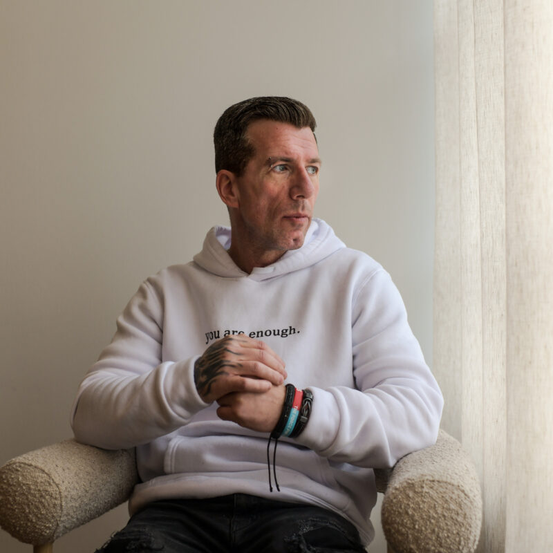 Man sat on a chair and looking out of window